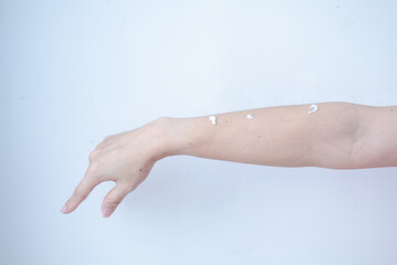 Woman's arm with skin cream waiting for skin care rub