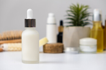 Fototapeta na wymiar Natural herbal eco cosmetics - cream or serum in a glass jar with a pipette dispenser