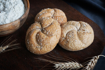 Fresh bread on the background of a plate with flour, a bottle of butter and eggs
