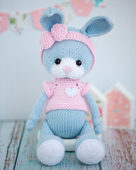 Adorable handmade knitted toy, a symbol of warmth and home comfort. concept of needlework and home comfort