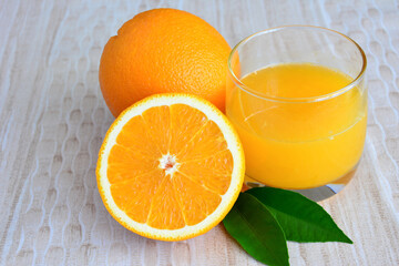 group of oranges with glass of orange juice isolated close up   