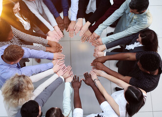 Business people stretched out their hands towards each other while standing in a modern office. view from ferhu