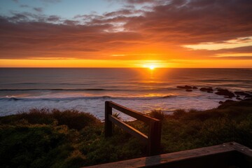 sunset over the ocean, viewed from a beach lookout