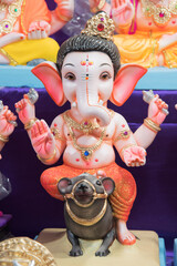 Idol of Bal Ganesha sitting on the rat at Ganesha festival, Pune, Maharashtra, India.