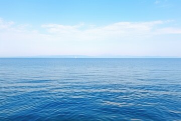 shot of a calm sea with horizon and wind turbines