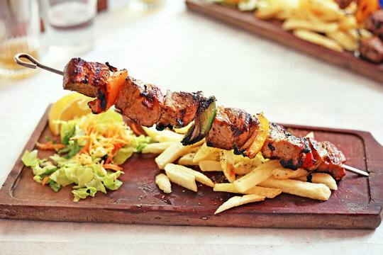 traditional greek souvlaki with chicken and potatoes - greek kontosouvli - greek cuisine