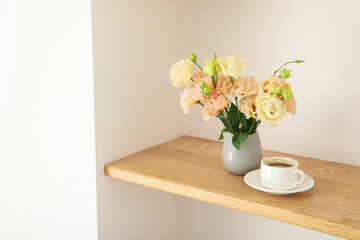 Coffee and a vase with flowers on the table