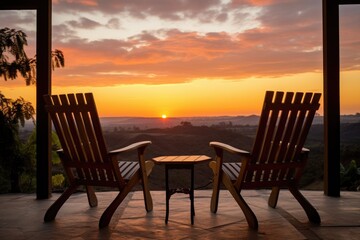 two patio chairs overlooking a sunrise