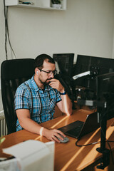 Portrait professional man programmer working concentrated on computer in diverse offices. Modern IT technologies, development artificial intelligence, programs, applications and video games concept.