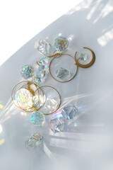 Clear quartz minerals and prisms refracting rainbow colors light close up on abstract white...