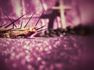 Lent, Holy Week, Ash Wednesday and Christianity Concept - crown of thorns close up with purple background.