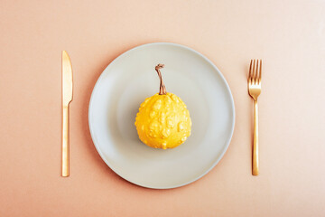 Autumn table place setting with grey plate with pumpkin on neutral background. Thanksgiving,...