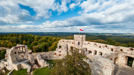 Tenczyn Castle in Rudno on the Trail of the Eagles' Nests. A beautifully situated fortress. Polish flag. Kraków-Częstochowa Upland. Poland