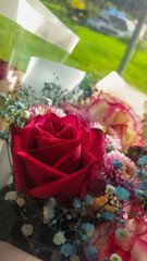A bouquet of flowers from red, pink dahlia roses and others