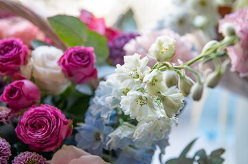 Beautiful bouquet of roses, gypsophila and other different flowers on dark background