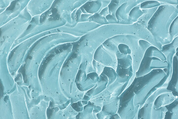 Obraz premium Transparent serum gel with hyaluronic acid for the face on a blue background. The texture of a cosmetic product with oxygen bubbles. Wellness and beauty concept.