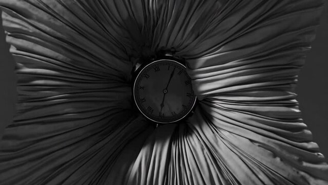 An old clock sinks into fabric in black and white