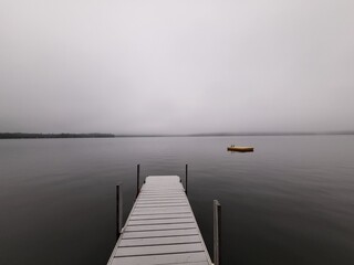 Fototapeta premium dock on a lake in morning fog