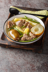 Slow Cooked Lamb Stew with Pears, Potatoes, Onions and Green Beans closeup on the plate on the table. Vertical