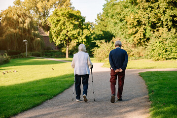 pensioners walking in the park. sunny day, autumn season.