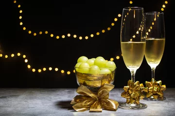 Rolgordijnen Two glasses of champagne with twelve grapes © JoseFelix