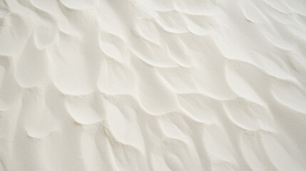 Top view of white sand, captured in close-up detail, displaying textured grains.