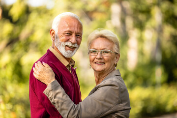 Portrait of happy senior couple in park.