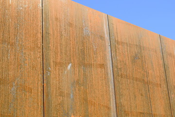 Rusty surface of weathering steel facade panels on the exterior of a building