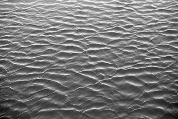 Wavy water texture surface from above in spring.