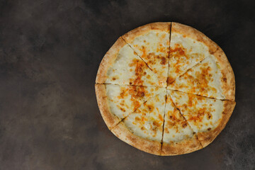 Italian pizza Margherita with cheese, tomato sauce on brown background top view.