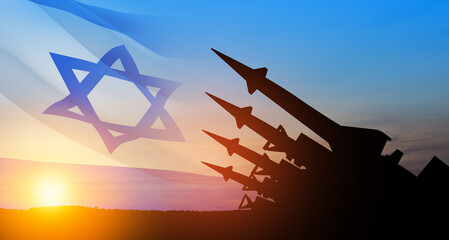 The missiles are aimed at the sky at sunset with Israel flag. Nuclear bomb, chemical weapons, missile defense, a system of salvo fire. - obrazy, fototapety, plakaty