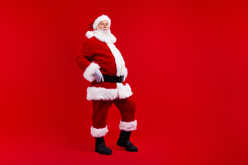 Full length photo of granddad santa claus posing empty space christmas ad isolated on vivid red color background