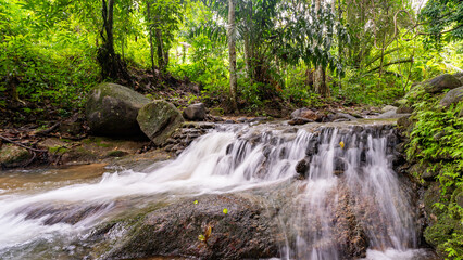 Waterfall in Abundant Clear Stream in the forest Small waterfall river with crystal clear water morning light nature background