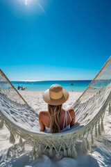 Beautiful girl in hat on sandy beach. Woman on seashore relaxing on swing on vacation