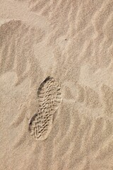 Sand dune with ripples and closeup of boot print.