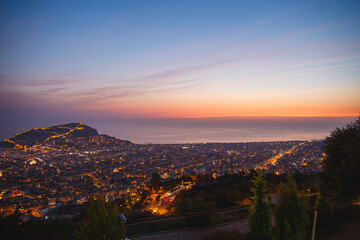 Fototapeta premium View from the mountains on Alanya, Turkey. Cityscape with sunset over the mountains