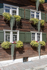 blossoming flowers on facade at old house, Obertstdorf, Germany