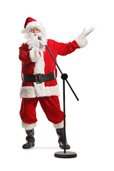 Cheerful santa claus with a microphone singing