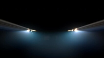 Close-up of an anonymous car's blinking headlights against a dark background in foggy lighting. Auto advertising concept, speed and lights.