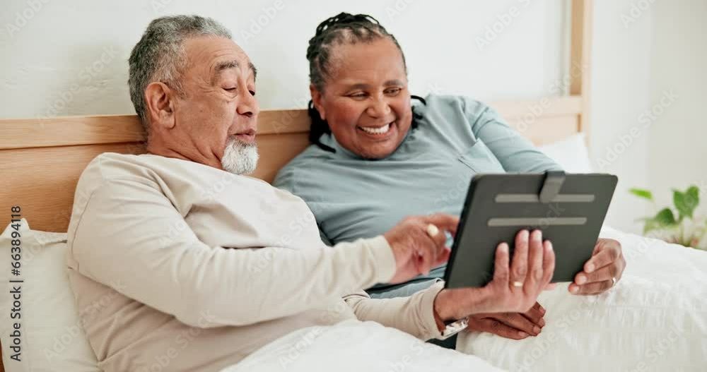 Wall mural Smile, tablet and mature couple in bed, typing and talking together in the morning. Technology, happy man and interracial woman in bedroom for funny meme on internet, laugh and social media at home