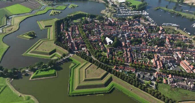 Aerial view on fortified historic city, surrounded by water canal as a defense system in medieval times.