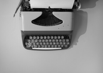 Vintage typewriter with paper. Old fashioned black and white concept. Retro header and text area.