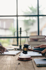 Male lawyer working with contract documents and wooden hammer on table in courtroom, justice and law, court judge, justice lawyer concept, legal advice and service vertical picture