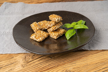Sunflower Seeds Bar on Black Plate, Energy Snack with Honey, Sun Flower Seed Muesli Dessert