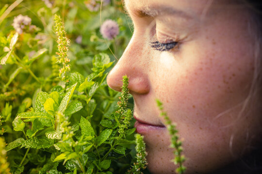 Woman smelling mint. Love for mint. Mint in the garden.