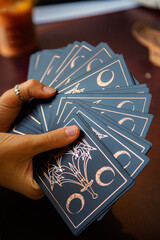 Hands of a woman holding tarot reading cards - obrazy, fototapety, plakaty