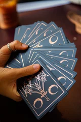 Poster Hands of a woman holding tarot reading cards © Tanya Maury