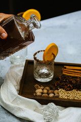 Pouring mulled cider in a vintage glass