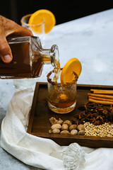Pouring mulled cider in a vintage glass