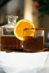Mulled cider with whole Cha&iuml; spices in vintage glass and jar